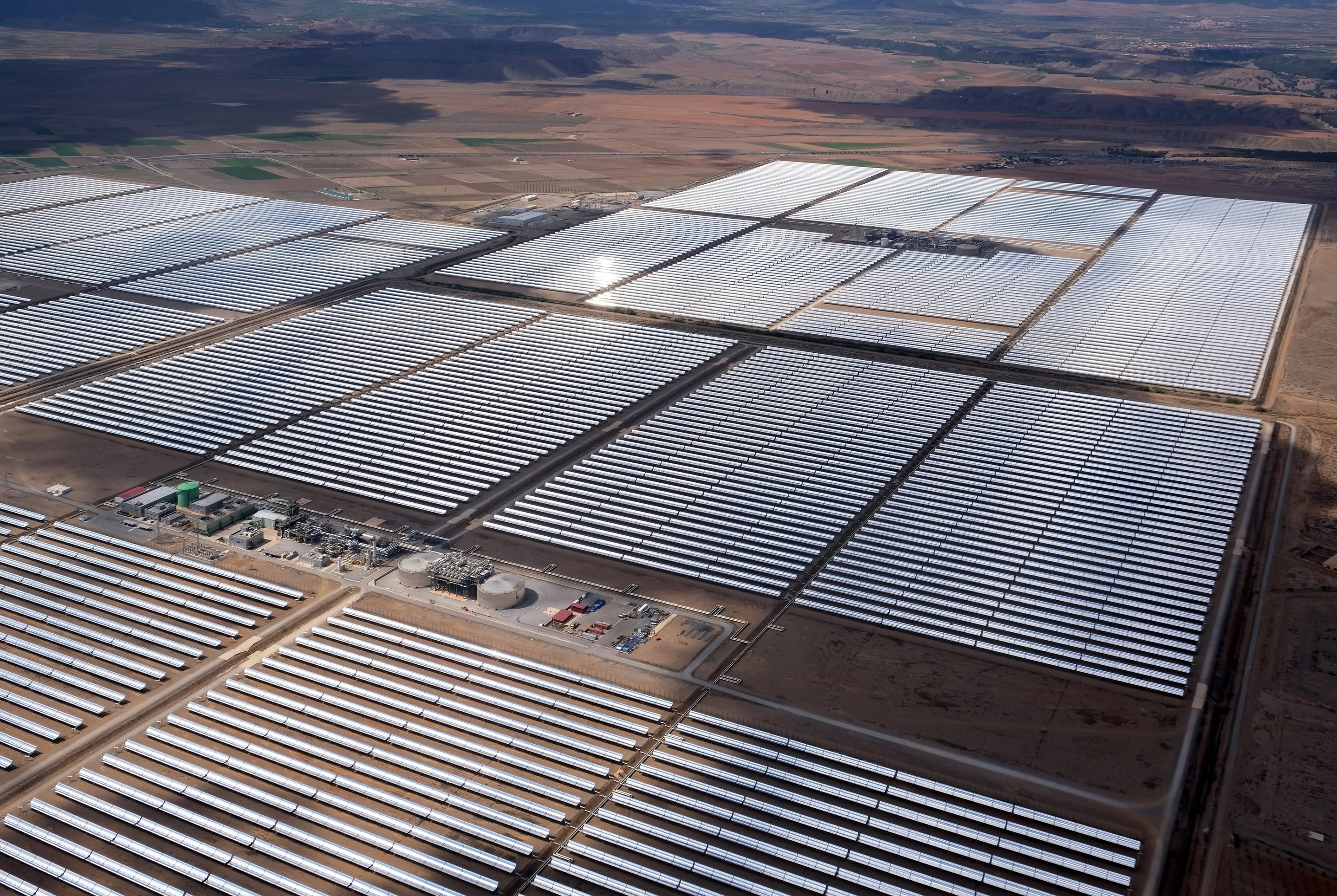 Aerial view of rows of solar collectors at a large solar power station